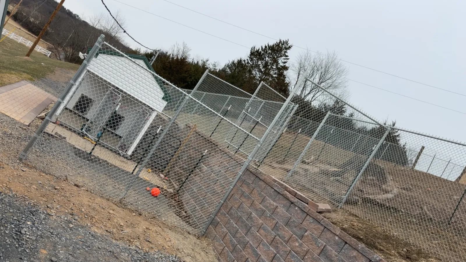Chain-link enclosure with walk and drive gates