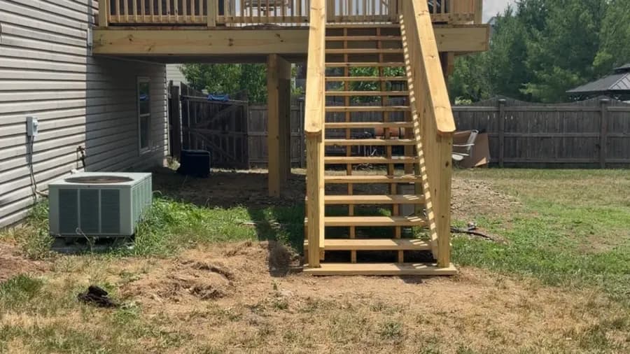 New pressure-treated elevated deck with railing and stairs