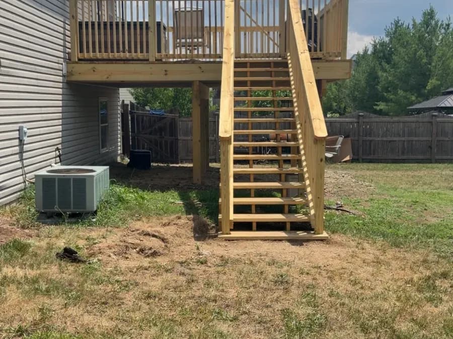 New pressure-treated elevated deck with railing and stairs
