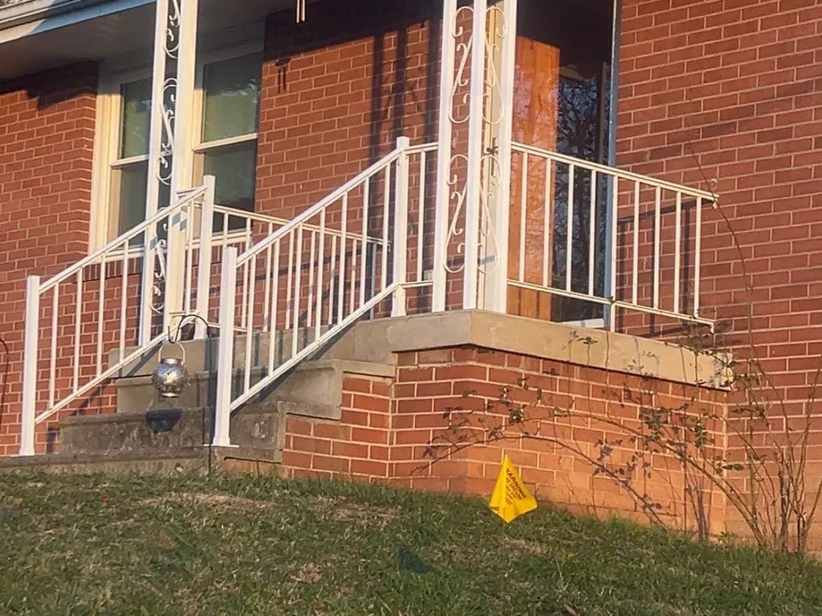 Decorative white aluminum railing panels at a brick patio