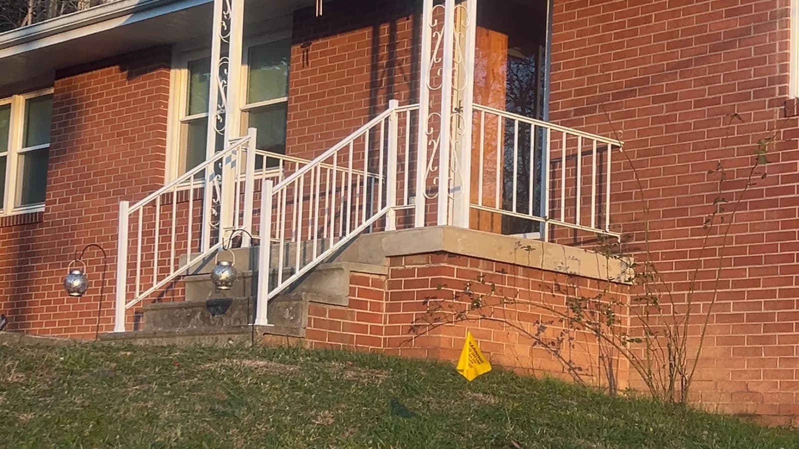 Decorative white aluminum railing panels at a brick patio