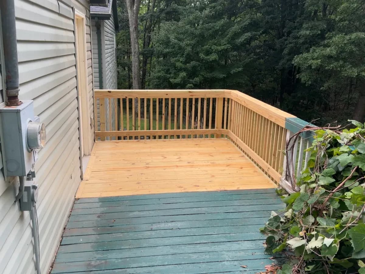 Rebuilt porch deck and new railings on an older home