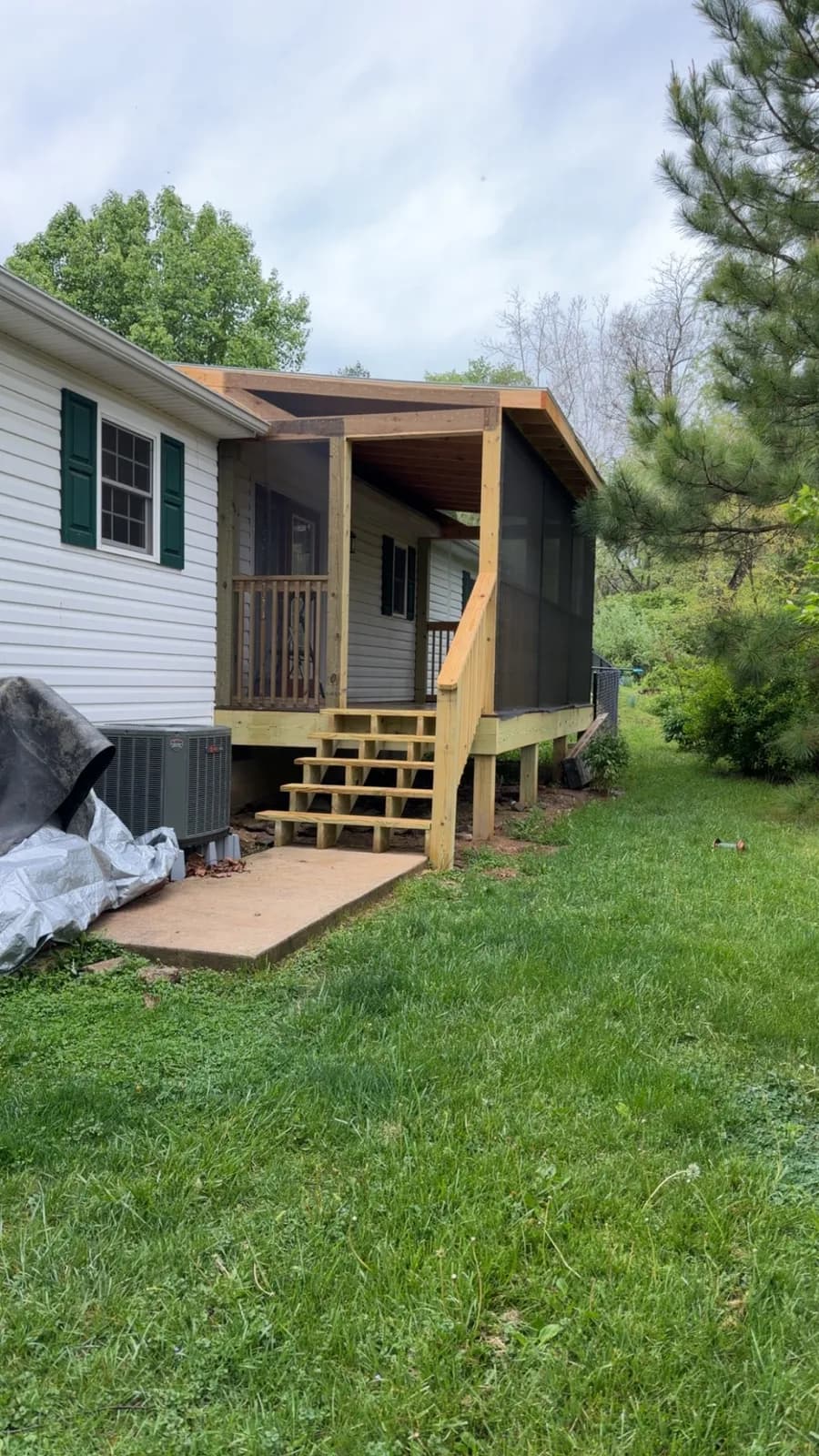 Screened porch addition framed and screened on a single-story home