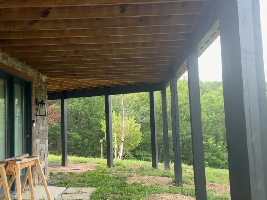 Underside of an elevated deck showing sealed joists and posts