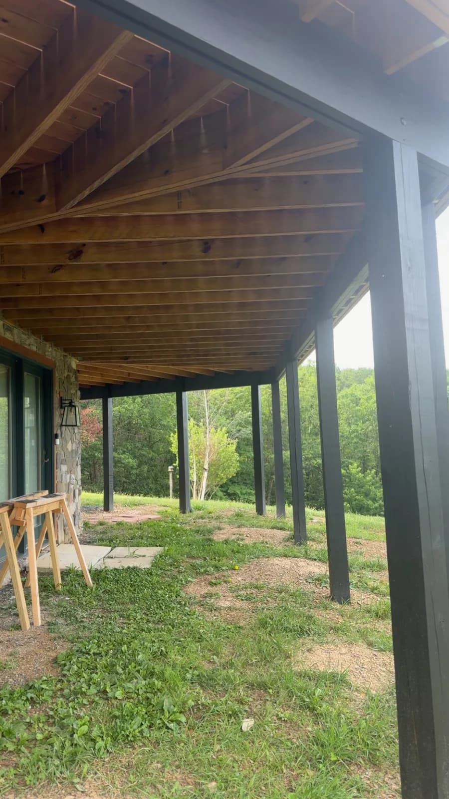 Underside of an elevated deck showing sealed joists and posts