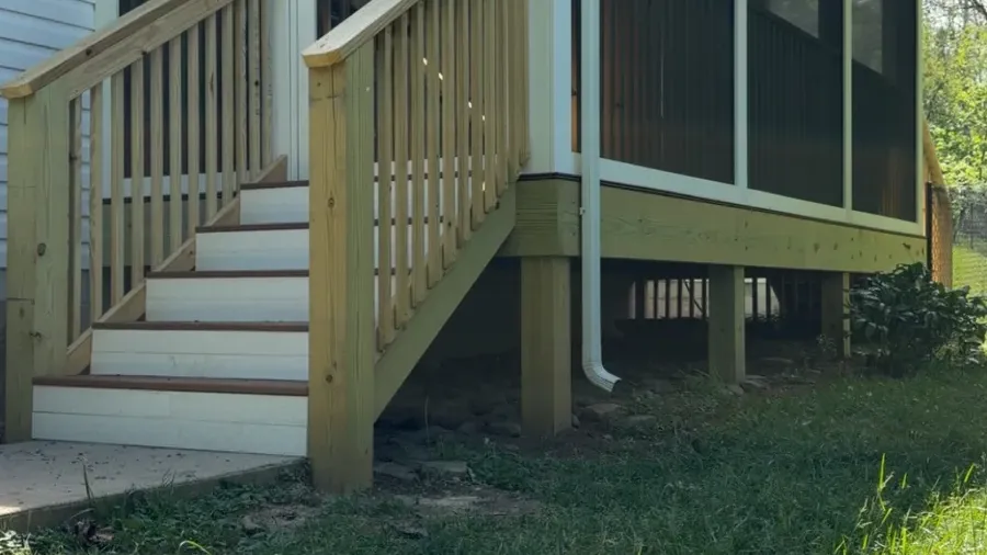 Finished screened porch addition with new wood stairs and white-framed screen panels